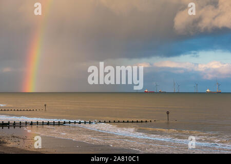 Sunset overlooking North Sea from Aberdeen esplanade & beach with rainbow and offshore wind farm, Northeast Scotland, UK Stock Photo