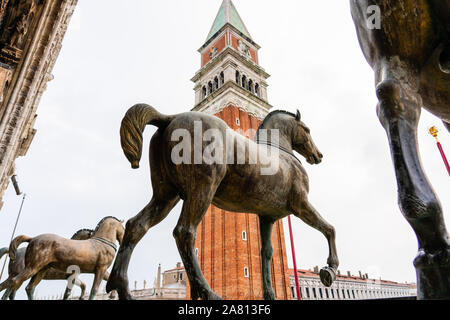 Horses of Saint Mark Cavalli di San Marco or Triumphal Quadriga on the facade of St Mark's Basilica in Venice Italy looking towards the Campanile Stock Photo