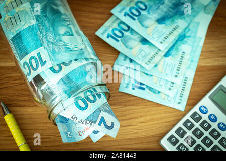 Brazilian money on the desk with a pen and calculator Stock Photo