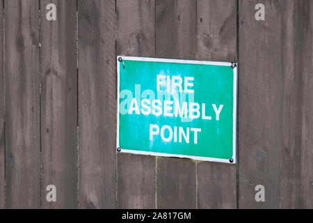 Fire assembly point sign at office work place Stock Photo