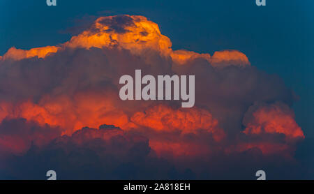 Red storm cumulonimbus clouds at sunset light Stock Photo