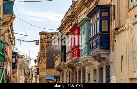 Residential house facade with traditional Maltese multicolored enclosed wooden balconies in Rabat, Malta. Authentic Ma Stock Photo