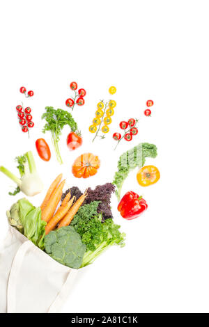 Zero waste heatlhy shopping concept. Vegetables flying out of the reusable cotton bag on white, top view, selective focus Stock Photo