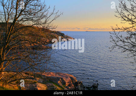 View to Gulf of Finland at sunset time in  October with peaceful blue sea. Kustaanmiekka, Suomenlinna, Finland. Stock Photo