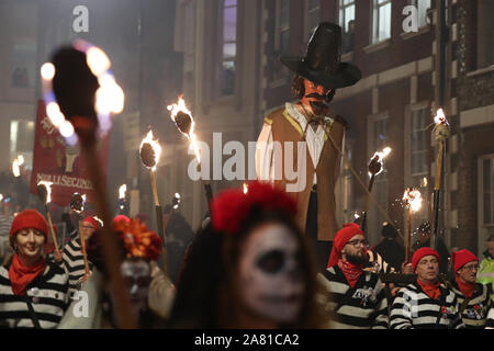 Participants parade through the town of Lewes in East Sussex during an annual bonfire night procession held by the Lewes Bonfire Societies. Stock Photo