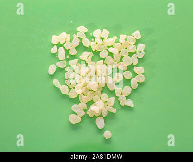 Mastic resin tears. Chios mastic on green color background, top view Stock Photo