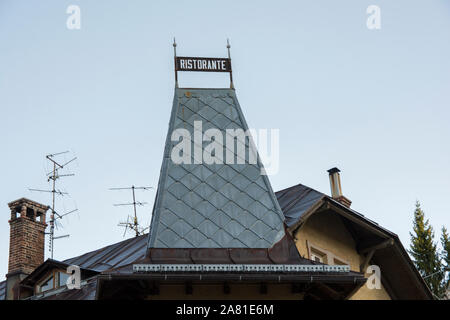 "Ristorante" sign (In Italian: Restaurant ) on top of a building, Cortina d'Ampezzo, Italy. Stock Photo