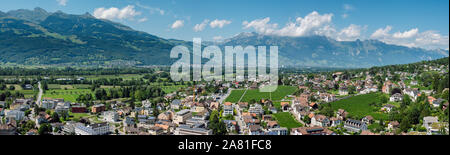 Beautiful panoramic summer view of the capital of Liechtenstein Vaduz and the Swiss Alps in the background. Stock Photo