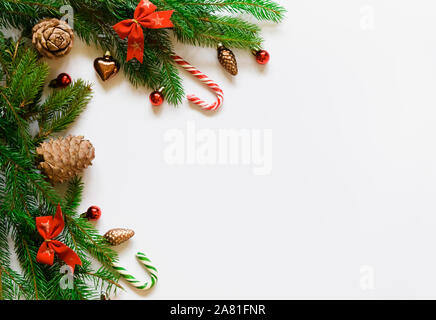 top view, green branches of spruce together with New Year's toys and bows on a white background Stock Photo