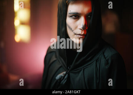 Close-up portrait of a beautiful man's face with Halloween make-up. Stock Photo