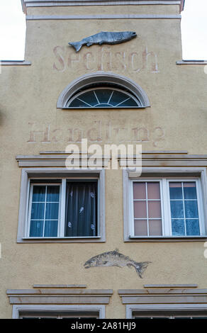 Windows with decorations on the wall of renovated old tenement house in Gdansk Old Town, Poland Stock Photo