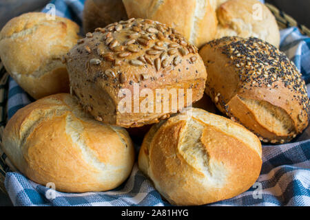 various types of fresh bread rolls in a basket in closeup Stock Photo