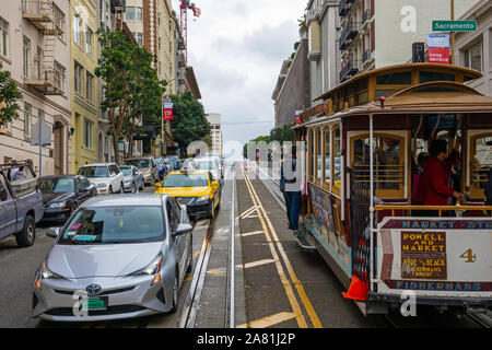 SAN FRANCISCO - February 08, 2019: Cable car on San Francisco streets. It’s the world's last manually operated cable car system and is the icon of the Stock Photo