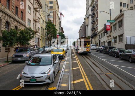 SAN FRANCISCO - February 08, 2019: Cable car on San Francisco streets. It’s the world's last manually operated cable car system and is the icon of the Stock Photo