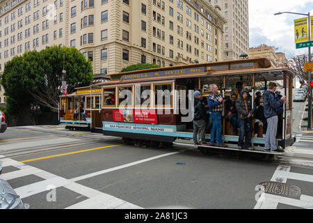 SAN FRANCISCO - February 08, 2019: Cable car on San Francisco streets. It’s the world's last manually operated cable car system and is the icon of the Stock Photo