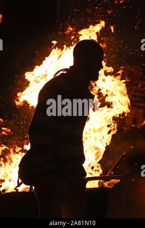 Participants parade through the town of Lewes in East Sussex during an annual bonfire night procession held by the Lewes Bonfire Societies. Stock Photo