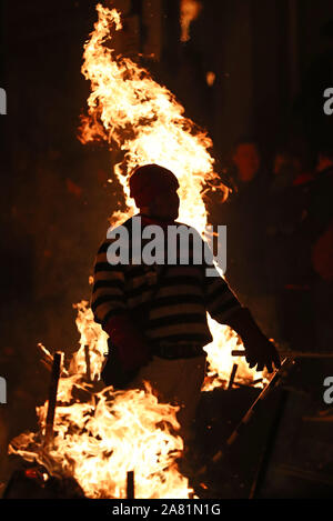 Participants parade through the town of Lewes in East Sussex during an annual bonfire night procession held by the Lewes Bonfire Societies. Stock Photo