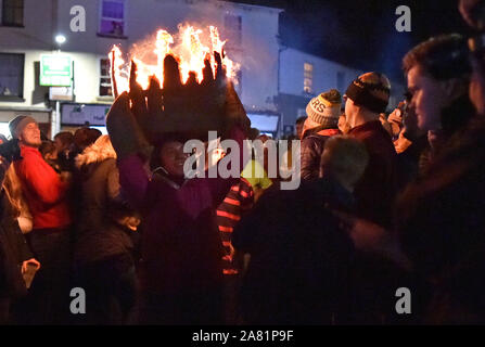 Participants in the village of Ottery St Mary in Devon carry traditional burning tar barrels through the streets of the village on bonfire night. Stock Photo
