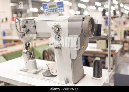 Industrial sewing machine in the work shop. Shoe manufacturing. Stock Photo