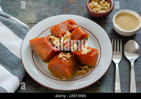 Pumpkin dessert , walnuts and tahini on wooden table. Stock Photo
