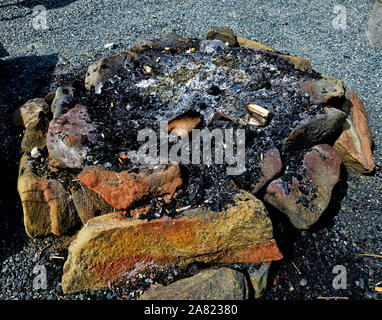 A round fire pit made from placing stones in a circle and used to burn wood for recreation and enjoyment. Stock Photo