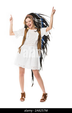 full length view of hippie girl in indian headdress dancing isolated on white Stock Photo