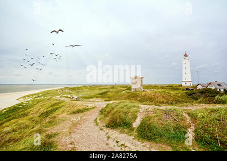 Lighthouse and bunker in the sand dunes on the beach of Blavand, Jutland Denmark Europe Stock Photo