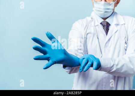 doctor puts on rubber gloves, healthcare and medicine. Stock Photo