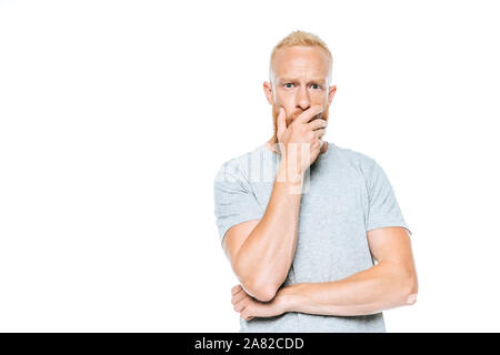 handsome worried bearded man in grey t-shirt, isolated on white Stock Photo