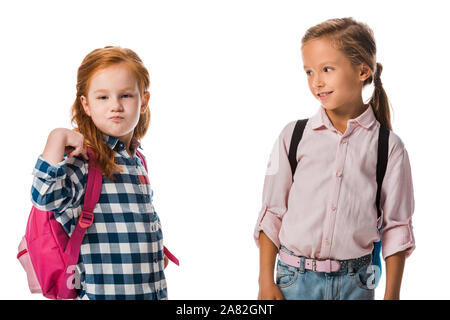 cute schoolkid looking at pupil with backpack isolated on white Stock Photo