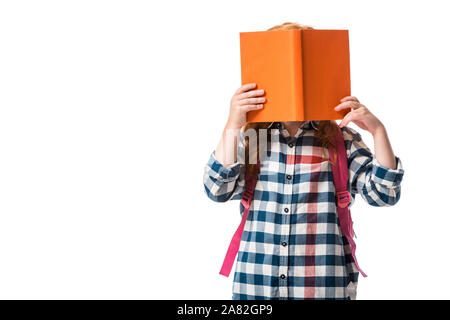 pupil covering face with orange book isolated on white Stock Photo