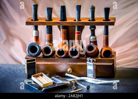 classic pipes on wood rack with tools Stock Photo