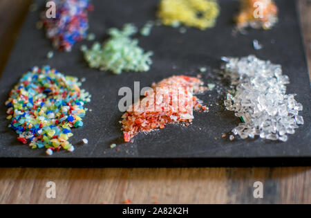 Close up of glass frit, the tiny particles of color that are often added to blown glass, marbles, beads and other glass projects Stock Photo