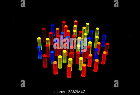colored acrylic pegs are illuminated when placed in this grid that is lit from behind Stock Photo
