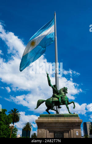 Buenos Aires, Argentina. October 26, 2019. The flag of Argentina (Bandera argentina - Bandera Nacional) and the equestrian monument to General Manuel