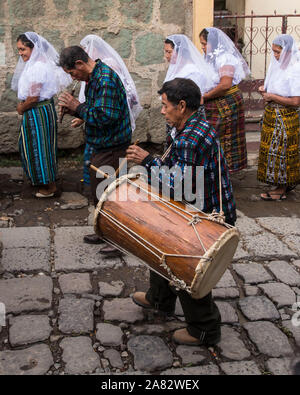 A traditional drummer and flute player in the Catholic procession of the Virgin of Carmen in San Pedro la Laguna, Guatemala.  Women in traditional May Stock Photo