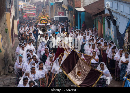 Catholic procession of the Virgin of Carmen in San Pedro la Laguna, Guatemala.  Women in traditional Mayan dress with white mantillas over their heads Stock Photo
