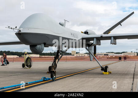 General Atomics MQ-9 Reaper drone flying over the mountains at sunset ...