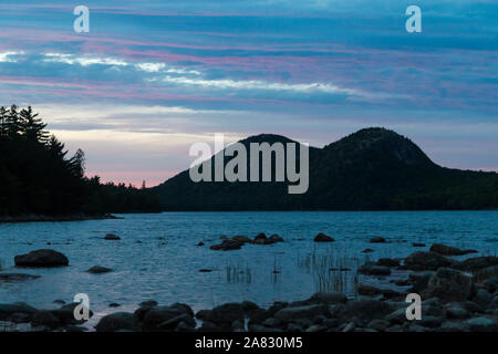 A landscape view of Jordan Pond during sunset in Acadia National Park in Maine. Stock Photo