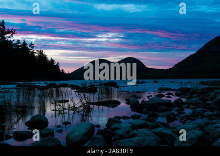 A landscape view of Jordan Pond during sunset in Acadia National Park in Maine. Stock Photo