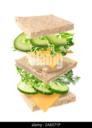 Tasty sandwich with flying ingredients on white background Stock Photo