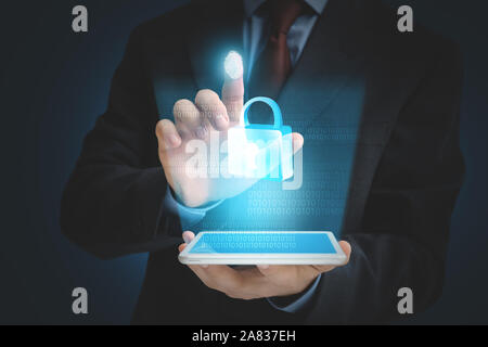 Businessman with tablet computer using fingerprint protection for data access Stock Photo