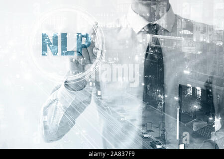 Double exposure of young businessman touching word NLP on virtual screen and illuminated city at night Stock Photo