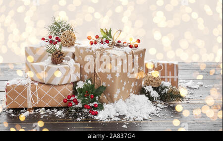Beautiful Christmas gifts on wooden table against defocused lights Stock Photo
