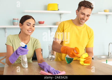 Young couple cleaning kitchen together Stock Photo