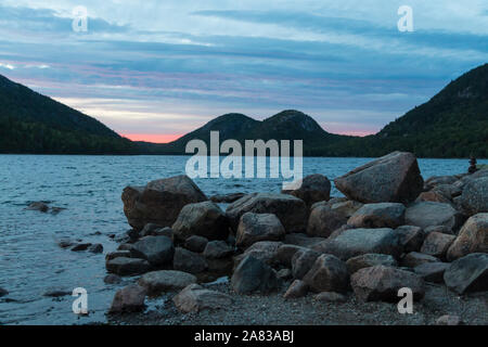 A landscape view of Jordan Pond during sunset in Acadia National Park in Maine. Stock Photo