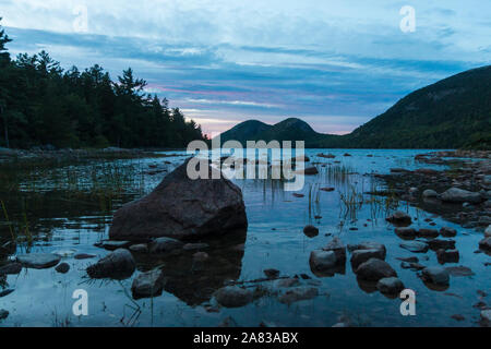 A landscape view of Jordan Pond during sunset in Acadia National Park in Maine. Stock Photo