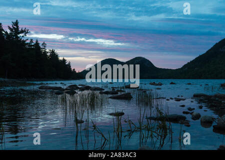 A landscape view of Jordan Pond during sunset in Acadia National Park in Maine. Stock Photo