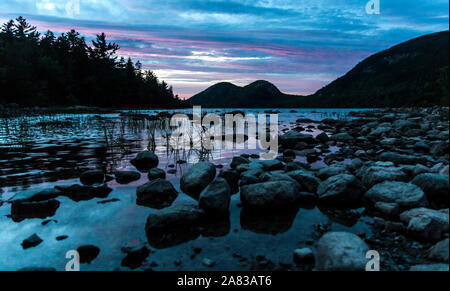 A landscape view of Jordan Pond during sunset in Acadia National Park in Maine. Stock Photo