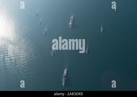 191104-N-KZ419-0002 ARABIAN GULF (Nov. 4, 2019) U.S. Navy ships and partner force ships conduct a formation as a part of the International Maritime Exercise 2019. IMX19 is a multinational engagement involving partners and allies from around the world in sharing knowledge and experiences across the full spectrum of defensive maritime operations. The exercise serves to demonstrate the global resolve in maintaining regional security and stability, freedom of navigation and the free flow of commerce from the Suez Canal south to the Bab-el-Mandeb through the Strait of Hormuz to the Northern Arabian Stock Photo